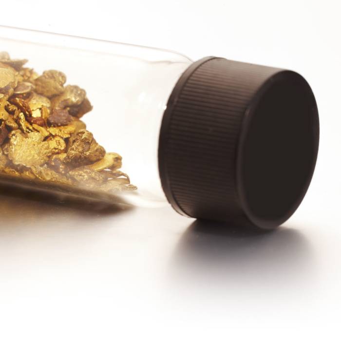 Glass vial filled with rare natural Welsh gold flakes and raw gold nuggets