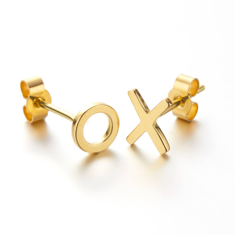 Close-up view of asymmetrical XO gold studs crafted in 20% Welsh gold and 80% Fairmined gold or 100% Welsh gold.