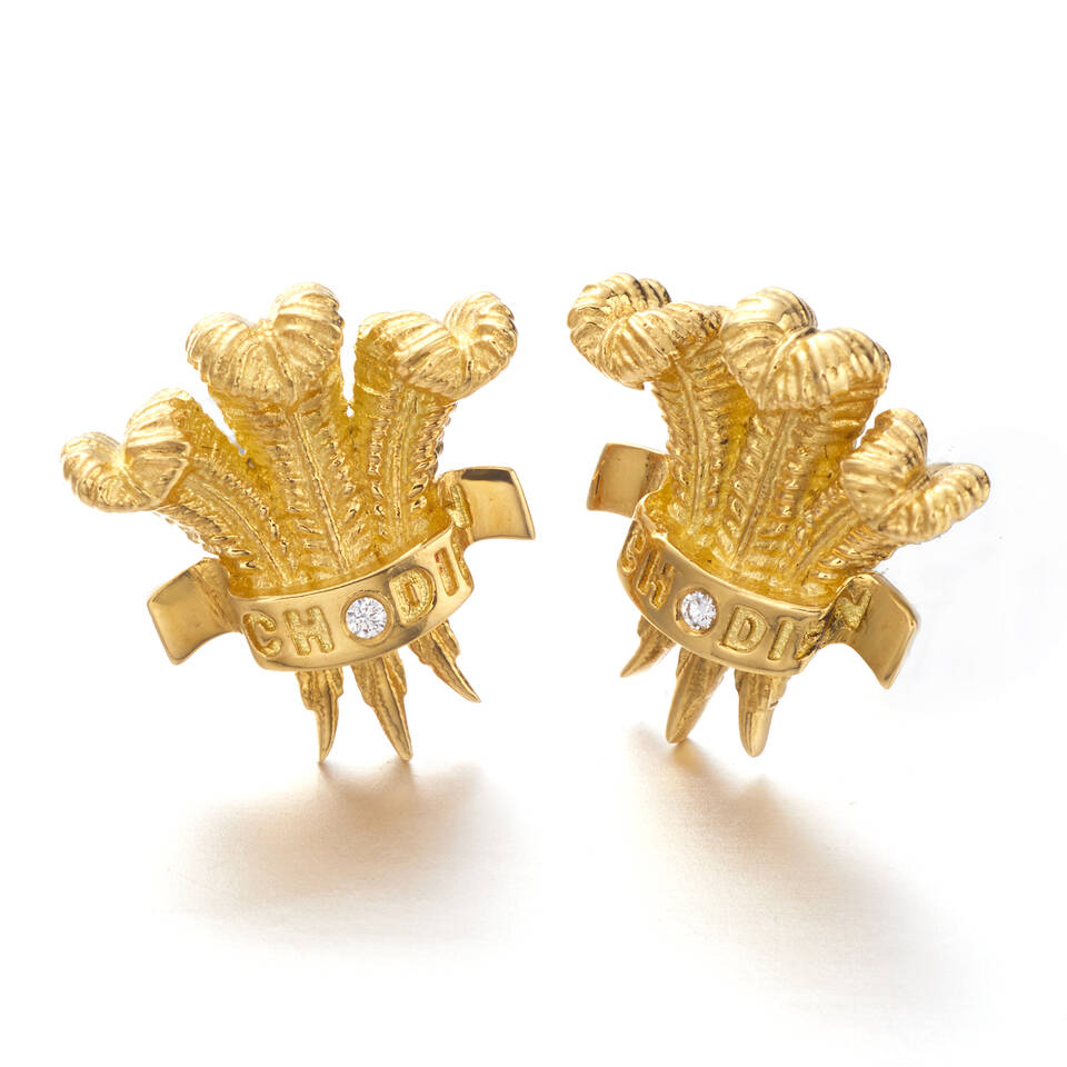 Luxurious handcrafted Welsh gold earrings inspired by traditional royal heraldry, featuring custom engraving and sparkling diamond accents on a three-feather motif.