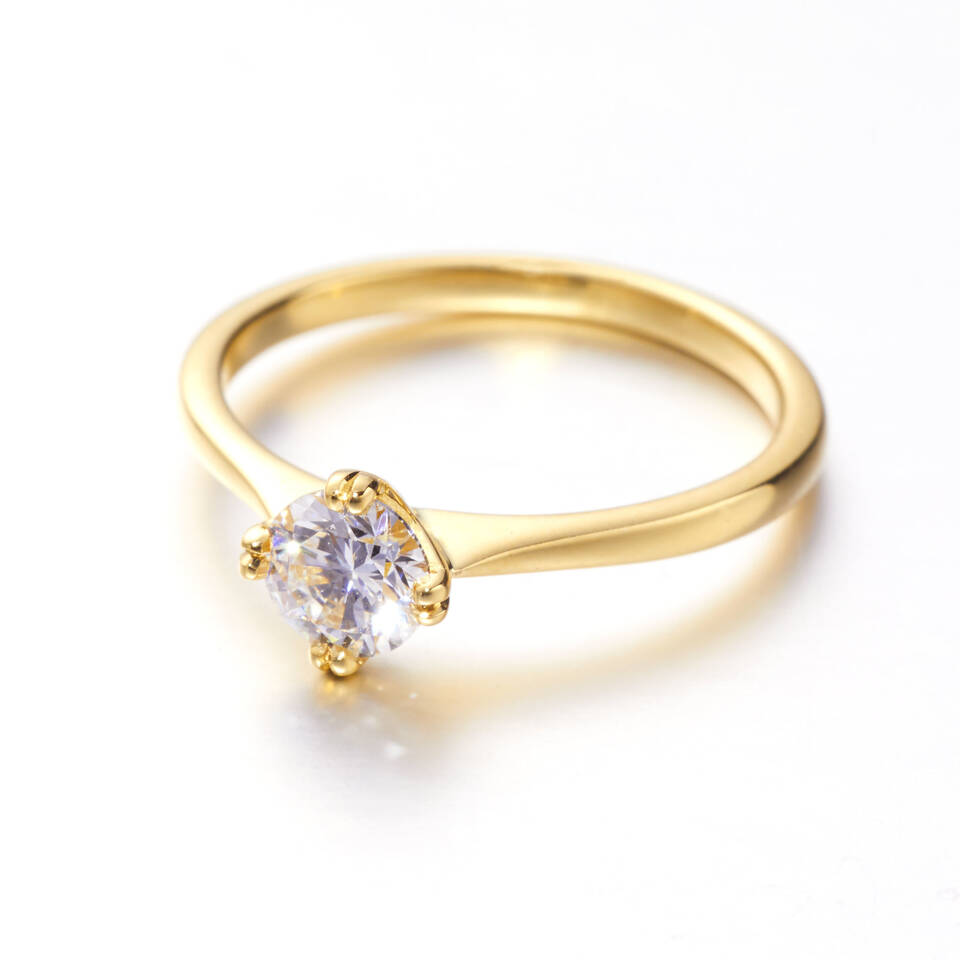 A high-polish Welsh gold engagement ring featuring a brilliant-cut diamond in a four-prong setting, with the band elegantly tapering toward the center stone.