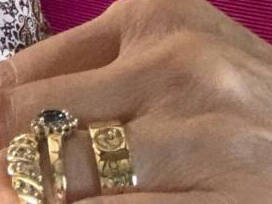 Close-up detail of a handmade Welsh gold ring showing intricate engravings of a Welsh Dragon and Mt. Fuji.