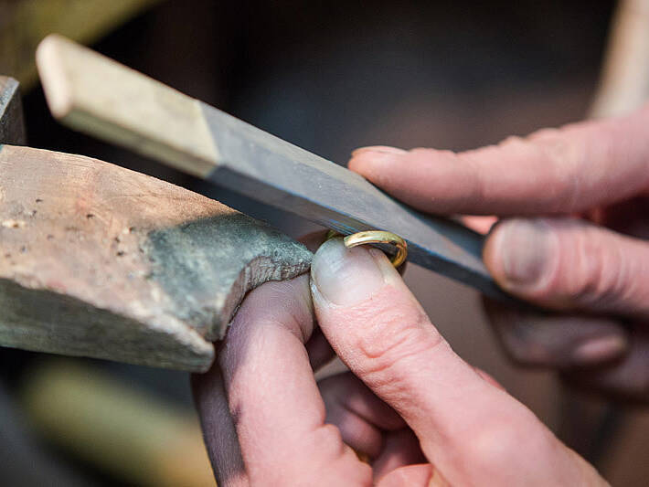 Handcrafting a Welsh gold ring: an artisan uses traditional filing techniques to ensure a perfect, comfortable profile for the bespoke jewellery.