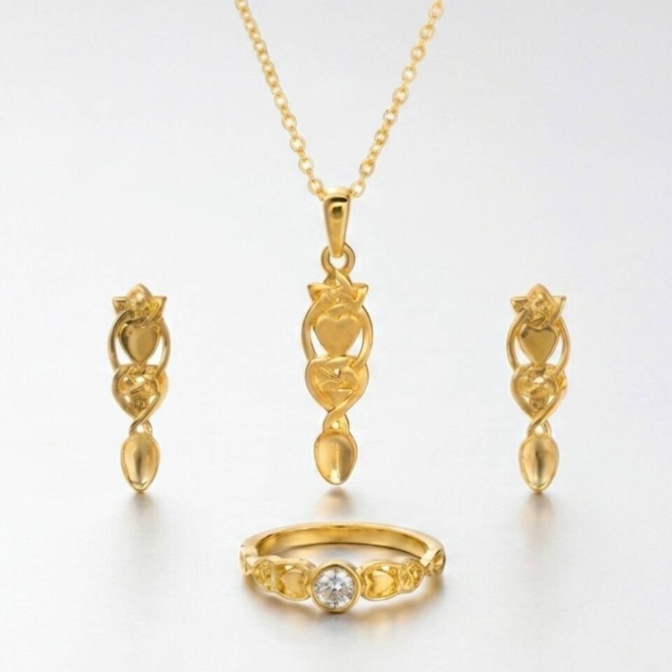 The 100% Welsh gold Love Spoon pendant displayed alongside matching Welsh gold Love Spoon drop earrings and a solitaire diamond ring.