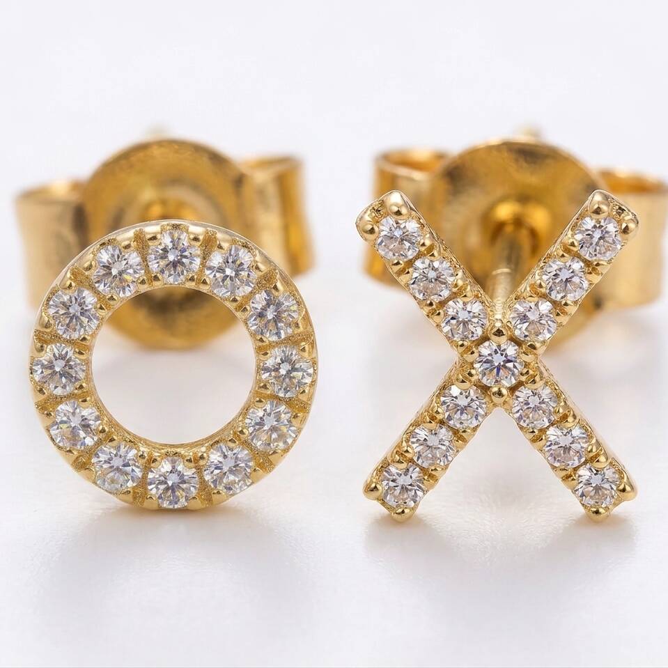 Detailed front macro view showing pavé set diamonds on Welsh gold X and O stud earrings