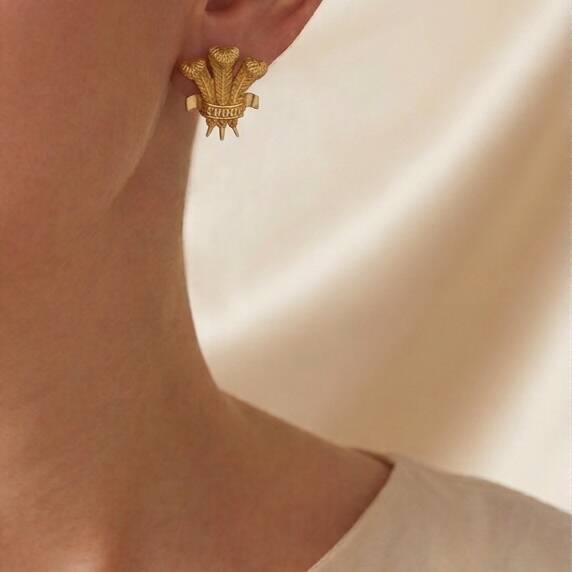 Woman wearing 100% pure 18ct Welsh gold Prince of Wales Feathers diamond earrings showing fit and size