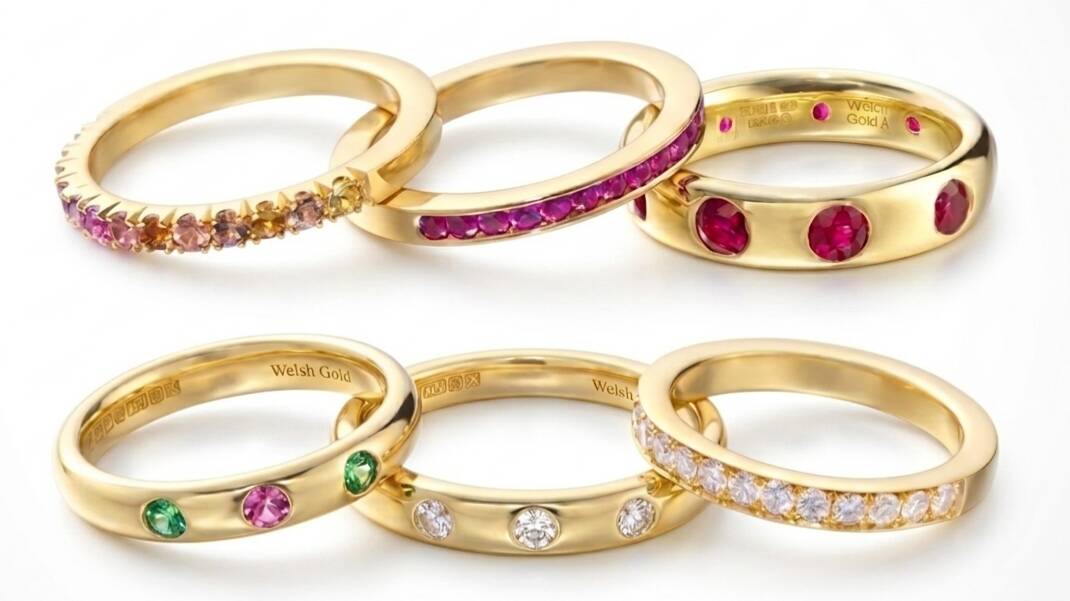 Selection of 100% and 20% Welsh gold eternity rings set with diamonds, rubies, and sapphires