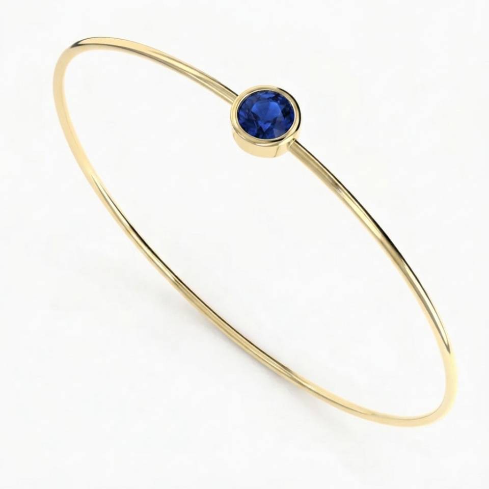 Handcrafted ultra-fine 18ct Eryri Welsh gold wire bangle set with a 5mm bezel blue sapphire