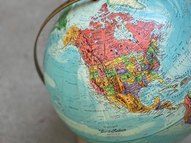 A close up of a map of North America showing America and Canada on a colourful globe.