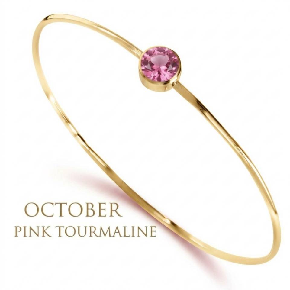 An 18ct Eryri Welsh gold 1.2mm wire bangle set with a natural October pink tourmaline gemstone