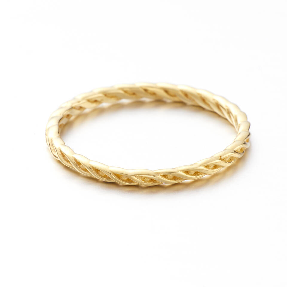 Delicate Celtic knotwork woven wedding ring on a white background available in 20% or 100% Welsh Gold.